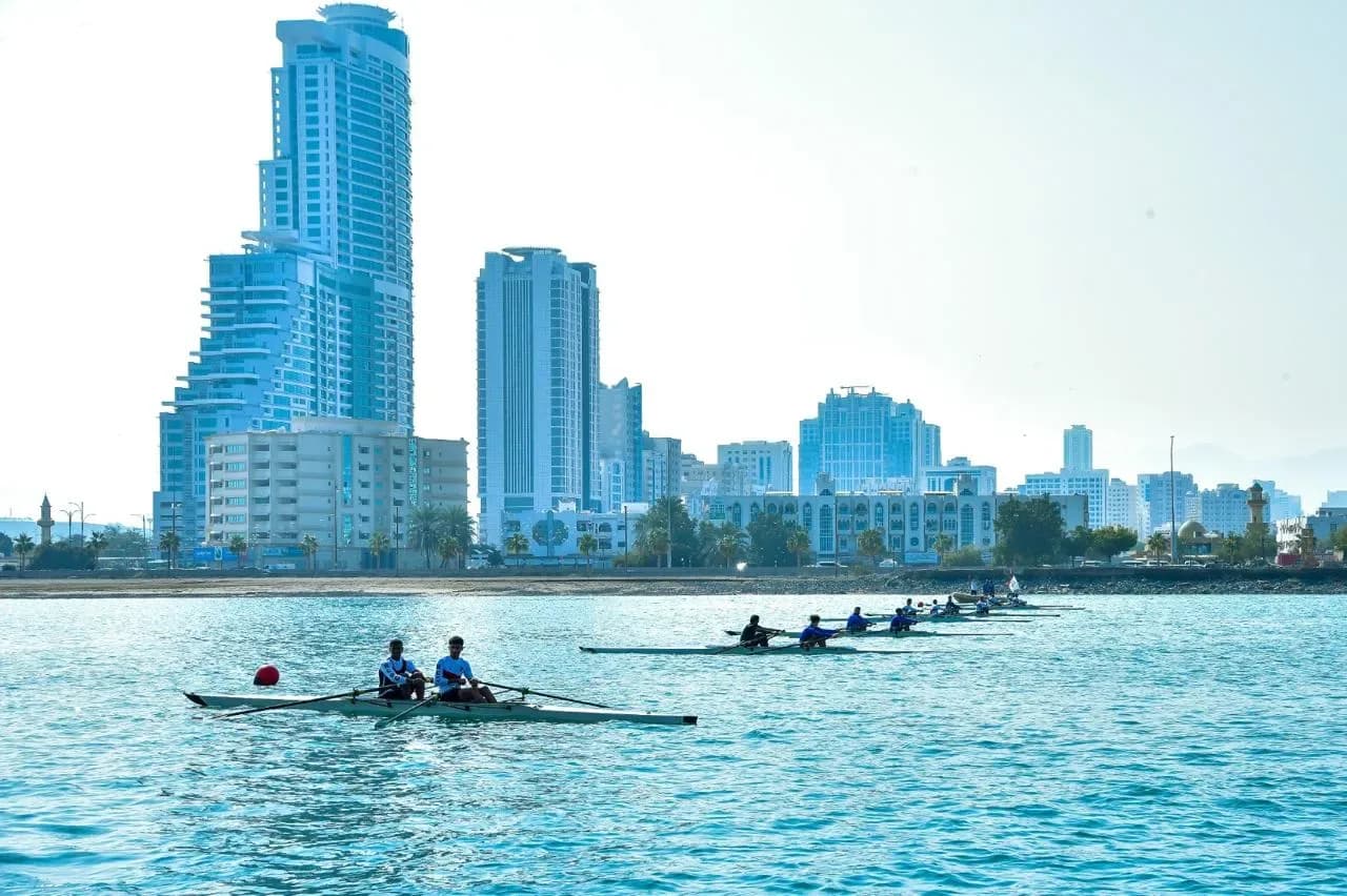 Rowing crews beside the city skyline