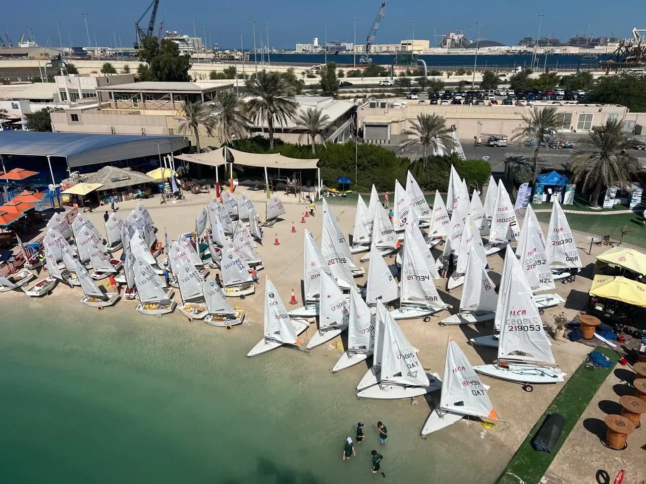 An Optimist fleet rigged on the beach before racing