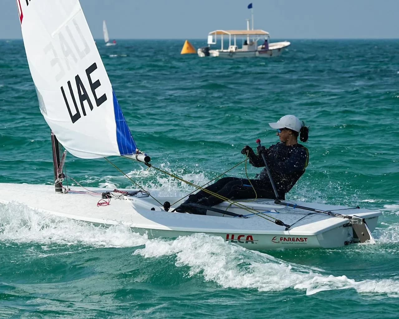 A UAE sailor hiking out of an ILCA dinghy